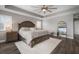 Bright main bedroom with a king bed, lots of light, and an ornate floor mirror at 8141 Carlton Ridge Dr, Land O Lakes, FL 34638