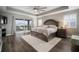 Spacious main bedroom with a king bed and balcony access with neighborhood views at 8141 Carlton Ridge Dr, Land O Lakes, FL 34638