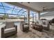Covered patio featuring comfortable seating, ceiling fan, and views of the pool and backyard at 8141 Carlton Ridge Dr, Land O Lakes, FL 34638