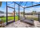 Covered patio featuring lounge chairs overlooking a backyard with a playground at 8141 Carlton Ridge Dr, Land O Lakes, FL 34638