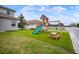 Backyard playground with slide, swings, and picnic table provides endless outdoor fun at 8141 Carlton Ridge Dr, Land O Lakes, FL 34638