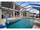 Screened-in lanai featuring a pool, a seating area, and a ceiling fan at 8141 Carlton Ridge Dr, Land O Lakes, FL 34638