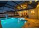 Enclosed pool area featuring a large, inviting pool with a basketball hoop, set against a backdrop of a well-maintained backyard at 8141 Carlton Ridge Dr, Land O Lakes, FL 34638