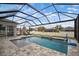 Screened-in pool with waterfall feature, lounge chairs, and basketball hoop offers a relaxing outdoor retreat at 8141 Carlton Ridge Dr, Land O Lakes, FL 34638