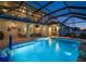 Stunning screened-in pool with water features, basketball hoop, and outdoor seating area, perfect for entertaining guests at 8141 Carlton Ridge Dr, Land O Lakes, FL 34638
