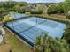 Aerial view of tennis courts, offering recreational opportunities for sports enthusiasts at 8141 Carlton Ridge Dr, Land O Lakes, FL 34638