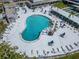 Aerial view of a swimming pool surrounded by lounge chairs and palm trees at 8454 111Th St # 201, Seminole, FL 33772