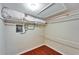 Walk-in closet with laminate wood floors and some items stored inside at 8454 111Th St # 201, Seminole, FL 33772