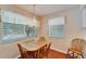 Cozy dining room area with hardwood floors, a chandelier, and natural light at 8454 111Th St # 201, Seminole, FL 33772