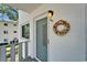Close up of condo door with wreath and unit number on a sunny day at 8454 111Th St # 201, Seminole, FL 33772