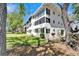 Bright white condominium building featuring screened-in lanais and lush landscaping at 8454 111Th St # 201, Seminole, FL 33772