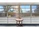 Florida room featuring expansive windows, carpeted floors, and a decorative table at 8454 111Th St # 201, Seminole, FL 33772