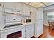 Functional kitchen with white appliances, tiled countertops, and sufficient cabinet space at 8454 111Th St # 201, Seminole, FL 33772