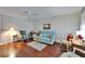 Cozy living room with wood floors, a ceiling fan, and comfortable seating at 8454 111Th St # 201, Seminole, FL 33772