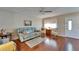 Inviting living room with a comfortable blue sofa and a decorative gold coffee table on a hardwood floor at 8454 111Th St # 201, Seminole, FL 33772