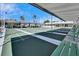 Organized shuffleboard courts with a covered canopy and bright green benches at 8454 111Th St # 201, Seminole, FL 33772