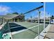 Organized shuffleboard courts with a covered canopy and bright green benches at 8454 111Th St # 201, Seminole, FL 33772
