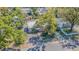 Charming home with a metal roof, lush landscaping, and mature trees in a desirable neighborhood at 8719 N Ola Ave, Tampa, FL 33604