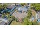 Aerial view of the property showing the roof, fenced backyard, shed, and surrounding neighborhood at 8719 N Ola Ave, Tampa, FL 33604