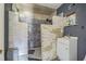 Unfinished bathroom featuring the partial stone shower, sink, and tiling at 8719 N Ola Ave, Tampa, FL 33604