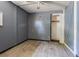 A bedroom with grey walls features new floors, closet, and a ceiling fan at 8719 N Ola Ave, Tampa, FL 33604