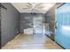 A bedroom with grey walls features new floors, closet, and a ceiling fan at 8719 N Ola Ave, Tampa, FL 33604