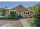 Inviting single-Gathering home featuring a charming front entry with decorative plants and well-maintained landscaping at 8719 N Ola Ave, Tampa, FL 33604