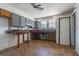 A kitchen features grey cabinets with a window allowing for ample natural light at 8719 N Ola Ave, Tampa, FL 33604