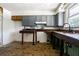 A kitchen features grey cabinets with a window allowing for ample natural light at 8719 N Ola Ave, Tampa, FL 33604