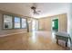 Spacious living room featuring hardwood floors, large windows, and a ceiling fan, perfect for relaxing or entertaining guests at 8719 N Ola Ave, Tampa, FL 33604