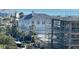 Bright, beach-style house with blue accents and new construction visible from afar at 880 Mandalay Ave # S514, Clearwater Beach, FL 33767