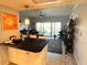 Bright living room featuring a black countertop, a balcony, and stylish decor at 880 Mandalay Ave # S514, Clearwater Beach, FL 33767