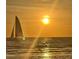 Lovely view of a sailboat sailing into the sunset, with sunlight glistening on the water at 880 Mandalay Ave # S514, Clearwater Beach, FL 33767