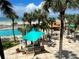 Inviting outdoor pool, grilling station, and dining area with a view of the beach at 880 Mandalay Ave # S514, Clearwater Beach, FL 33767