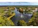 Beautiful aerial view of a community lake with a water fountain, surrounded by lush trees and stunning homes at 9314 Heritage Oak Ct, Tampa, FL 33647