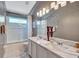 Elegant bathroom with marble countertops, double sinks, decorative vases and shower at 9314 Heritage Oak Ct, Tampa, FL 33647