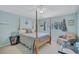 Bedroom featuring a four-poster bed, pale blue walls, and a decorative chandelier at 9314 Heritage Oak Ct, Tampa, FL 33647
