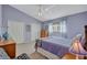 This bedroom features a ceiling fan, a window with curtains, and 2 closets at 9314 Heritage Oak Ct, Tampa, FL 33647