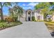 Charming two-story stucco home featuring a well-manicured lawn and a spacious driveway with mature landscaping at 9314 Heritage Oak Ct, Tampa, FL 33647