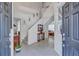 Inviting foyer with tile flooring, a staircase, and a view into the living room, creating a warm and welcoming atmosphere at 9314 Heritage Oak Ct, Tampa, FL 33647
