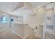 Bright hallway featuring an open staircase and ample natural light from an arched window at 9314 Heritage Oak Ct, Tampa, FL 33647