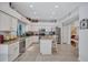 Well-lit kitchen features granite countertops, white cabinetry, stainless steel appliances and a center island at 9314 Heritage Oak Ct, Tampa, FL 33647