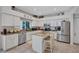 Bright kitchen with white cabinetry, granite countertops, stainless steel appliances, and a central island at 9314 Heritage Oak Ct, Tampa, FL 33647