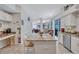 Bright, open kitchen featuring granite counters, an island with seating, and stainless steel appliances, perfect for Gathering meals at 9314 Heritage Oak Ct, Tampa, FL 33647