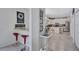 View of breakfast bar leading to kitchen with white cabinets, stainless steel appliances, and granite countertops at 9314 Heritage Oak Ct, Tampa, FL 33647
