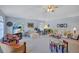 Spacious living room with large windows, comfortable seating, and a ceiling fan at 9314 Heritage Oak Ct, Tampa, FL 33647