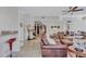 Spacious living room with tile flooring, leather furniture and open access to other rooms at 9314 Heritage Oak Ct, Tampa, FL 33647