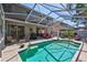The pool is surrounded by patio furniture and a screened enclosure at 9314 Heritage Oak Ct, Tampa, FL 33647
