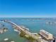 Stunning aerial view showcasing the waterfront property, bridge and expansive ocean views at 100 Bluff View Dr # 117C, Belleair Bluffs, FL 33770