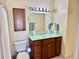 Bathroom with wood cabinets, sink, mirror, and good lighting at 100 Bluff View Dr # 117C, Belleair Bluffs, FL 33770